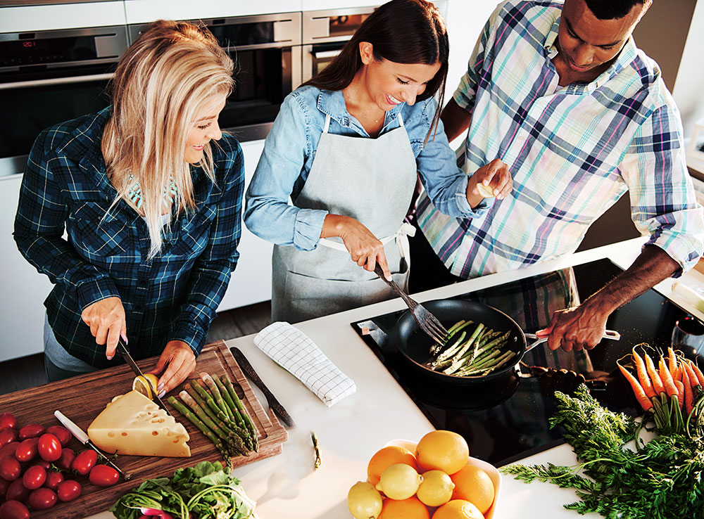 Photo of three people cooking together